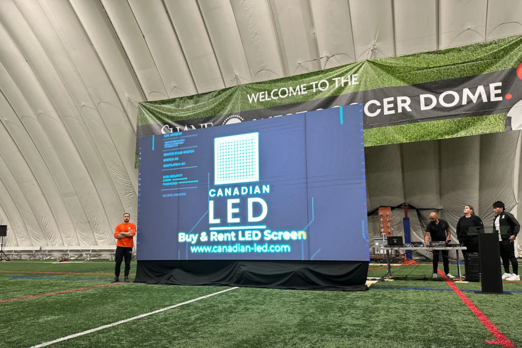 Large Canadian LED video wall display setup inside the Giant Soccer Dome with technicians preparing the screen for an event.