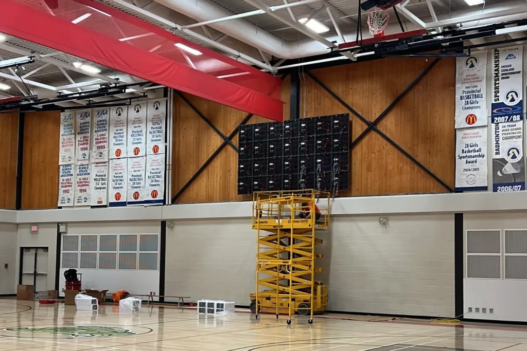 LED display installation process in a school gym