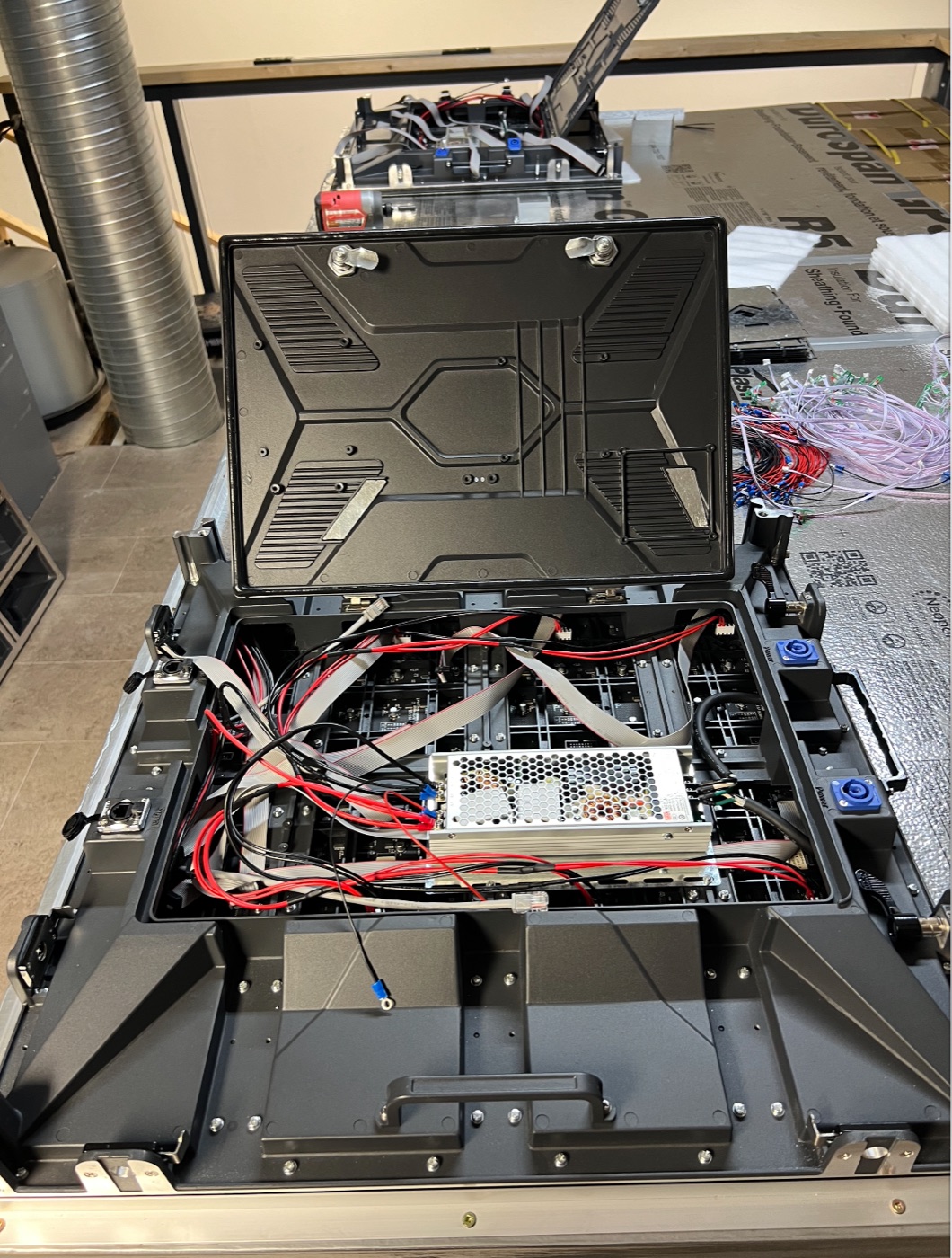 Opened LED screen cabinet showing internal power, data and service components