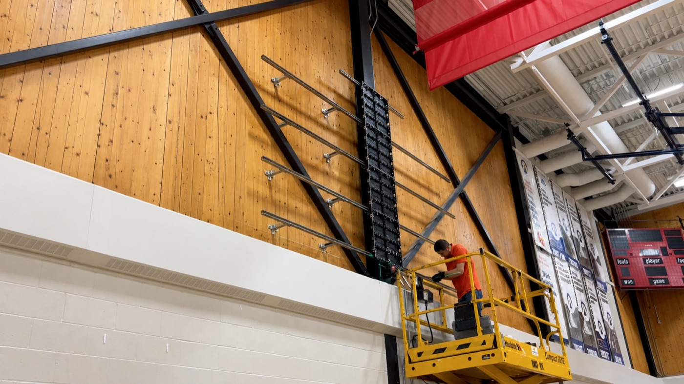 Custom metal mounting frame prepared for LED video wall panels in a gym